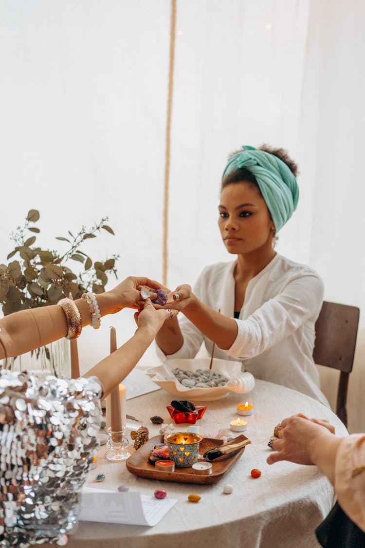 A Person Handing An Amethyst Crystal To A Woman