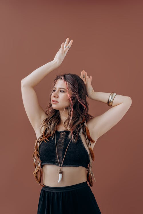 Woman in Blue Denim Vest Raising Her Hands