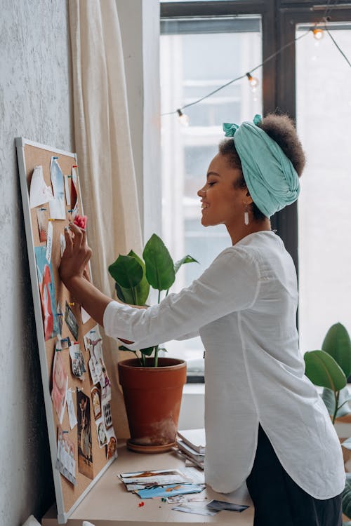 Woman in White Long Sleeve Shirt Wearing Teal Head Scarf