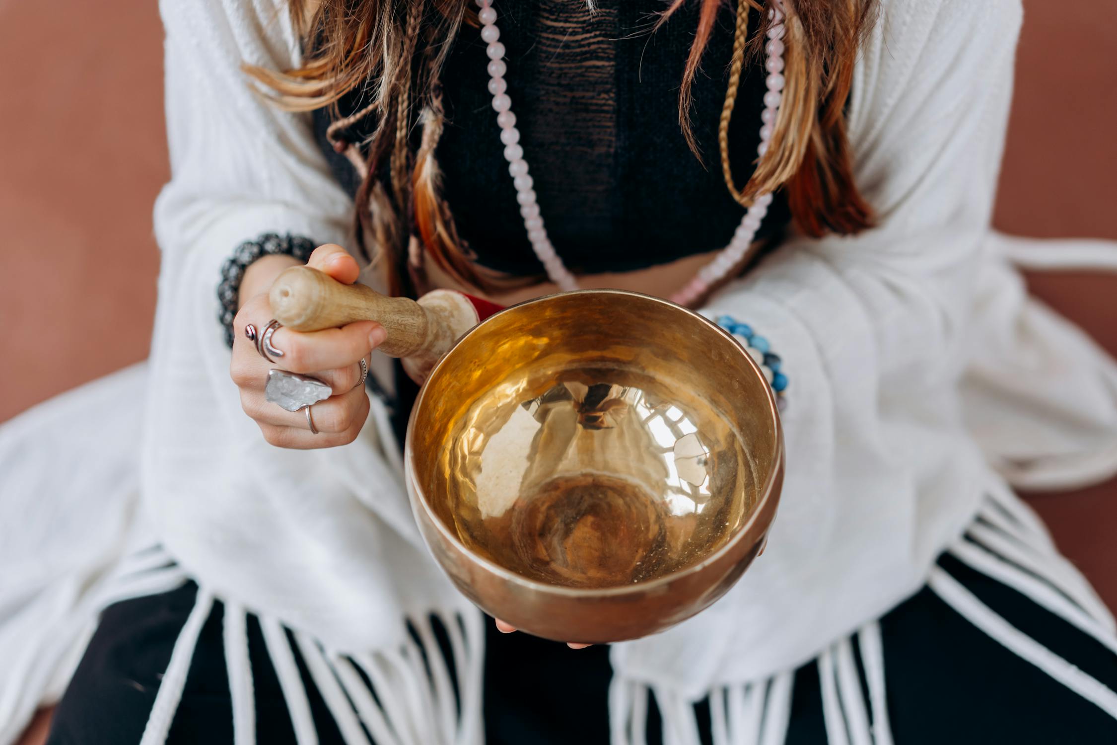 Woman sits with a singing bowl for meditation