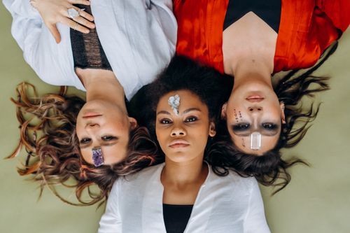 Free Three diverse women lying together with crystals on foreheads for meditation and relaxation. Stock Photo