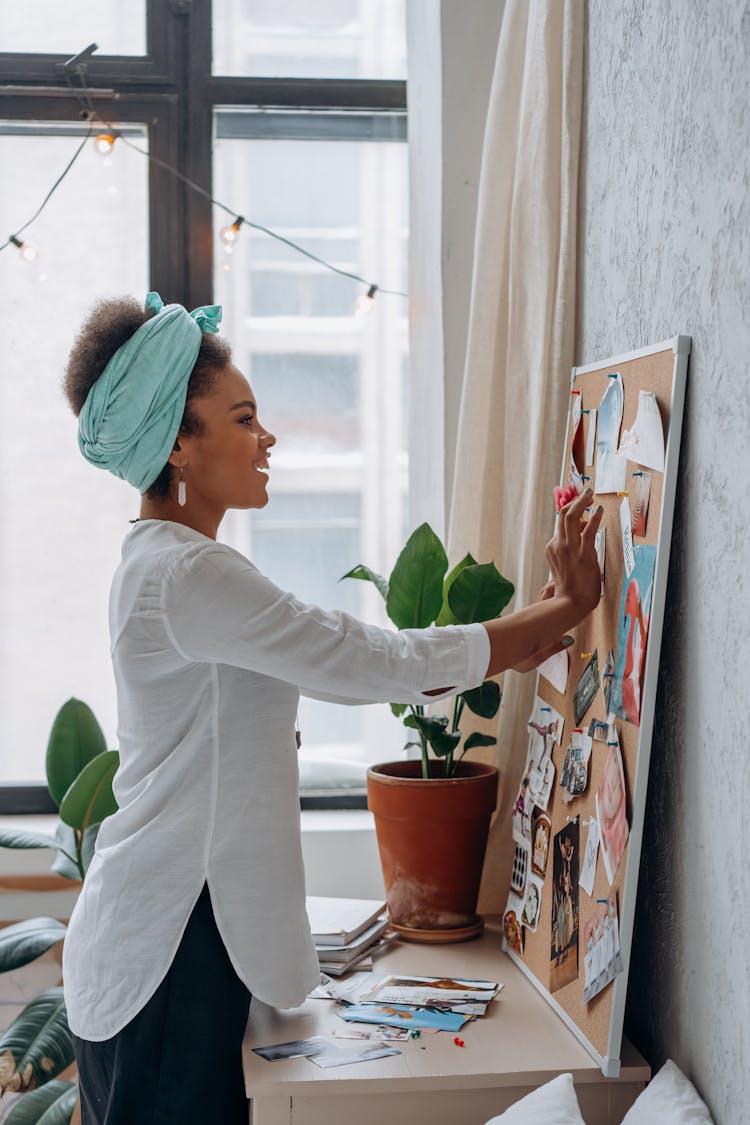 Woman Standing In Front Of A Corkboard