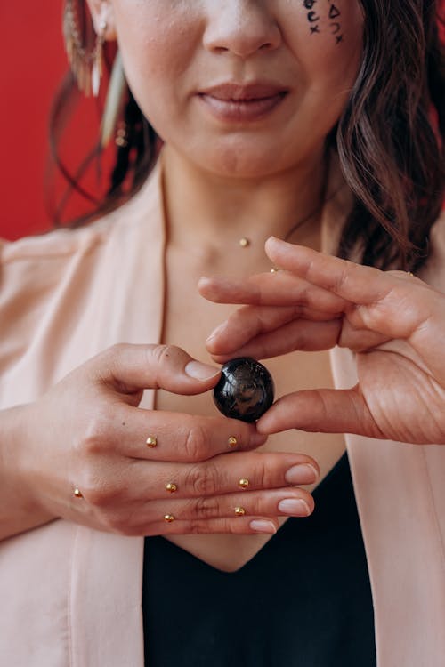 Woman Holding Black Round Ornament