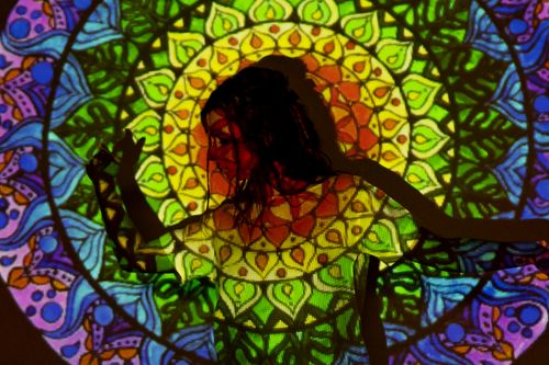 Free A vibrant mandala pattern projected onto a woman's silhouette, creating an artistic, esoteric atmosphere. Stock Photo