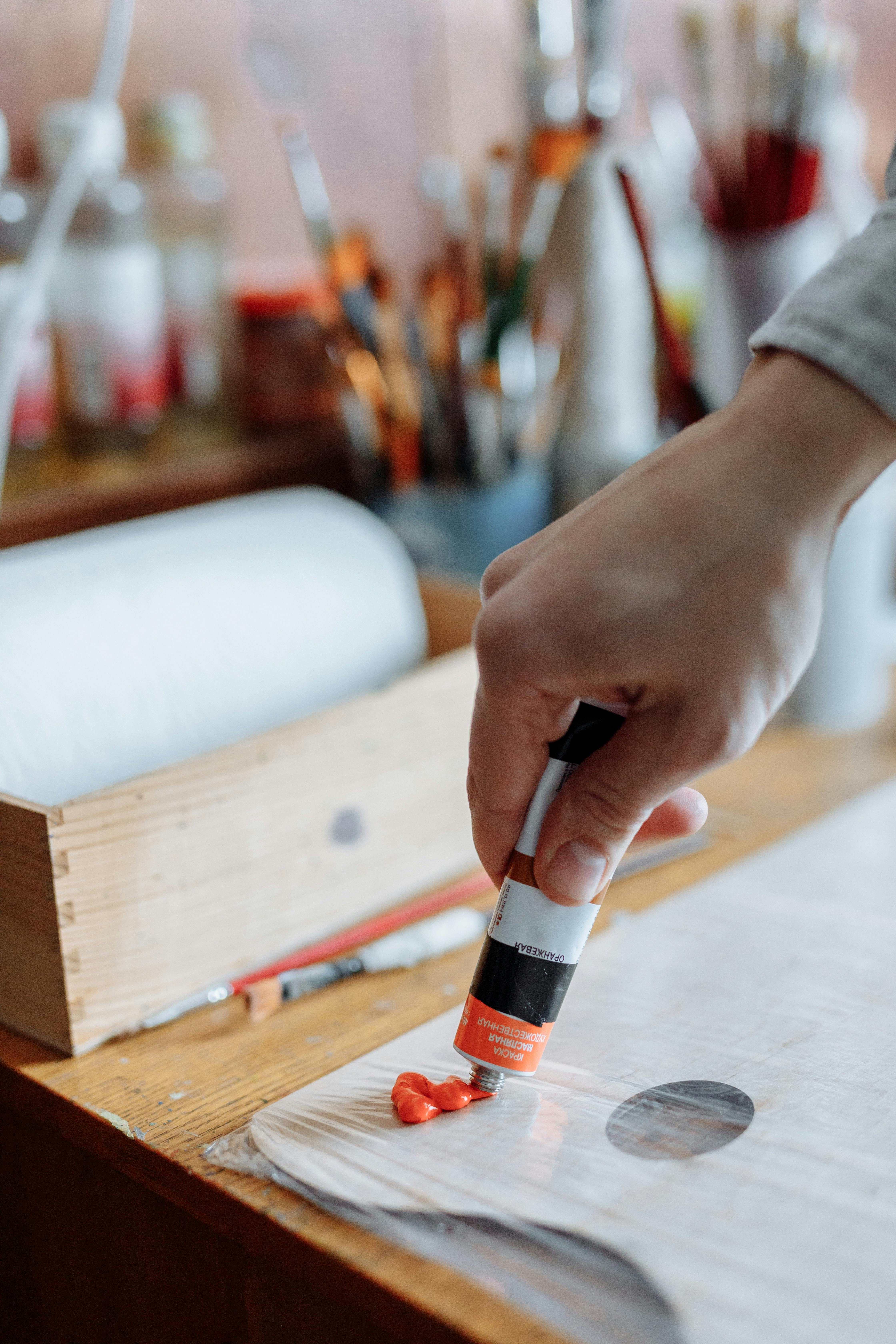 person holding black and orange tube