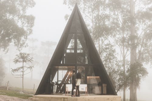 A Couple in Front of a Triangular House
