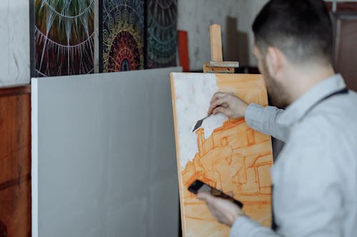 A Man Painting on a Canvas