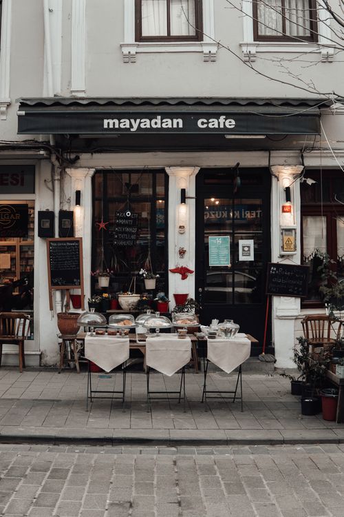 Free Exterior of street cafe with set table and chairs located near street in city in daylight Stock Photo