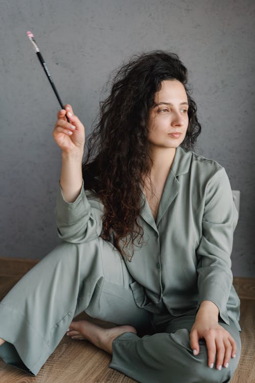Free Woman in Gray Pajama Holding Paintbrush Stock Photo