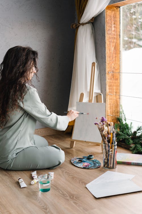 Woman Sitting on the while Painting