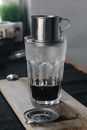 Clear Drinking Glass With Black Liquid on Brown Wooden Table