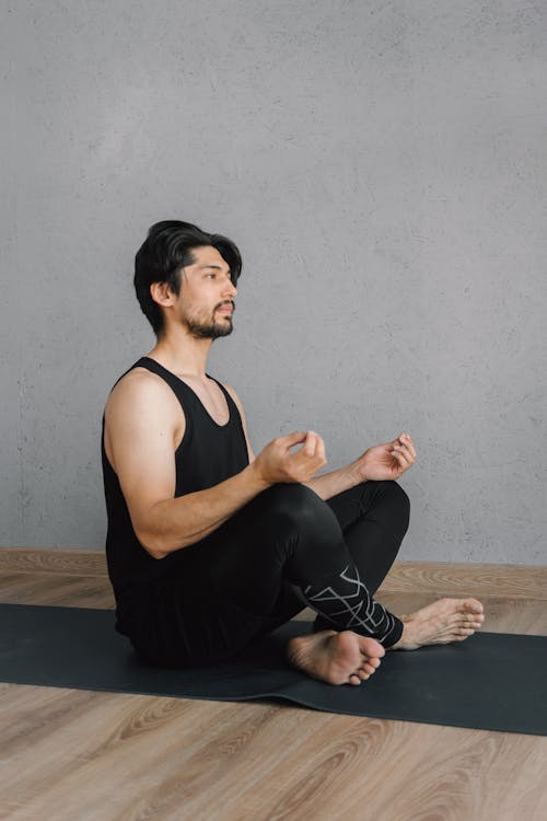 Man in Black Tank Top meditating