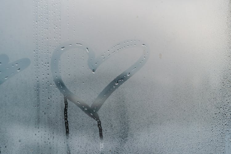 Heart Drawn Over Moist Glass Window