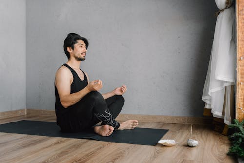 Photo of Man Meditating on Floor