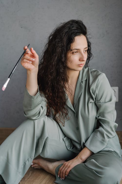 Woman Wearing Sleepwear Holding a Paintbrush