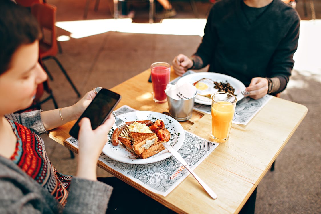 Free Two Dinner Plates on Square Brown Wooden Bar Table Stock Photo