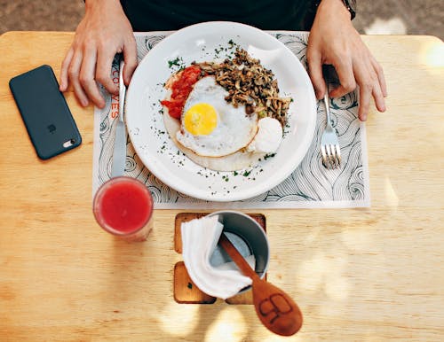 Free Fried Egg With Plain Rice on White Plate Beside Stainless Steel Fork With Clear Drinking Glass on Top Table Stock Photo