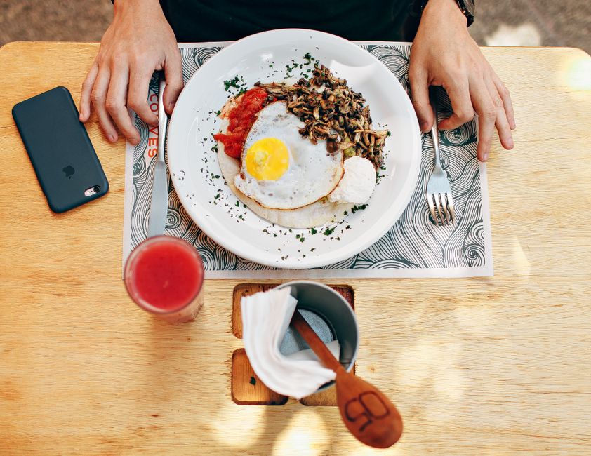 A casual restaurant table with plated lunch dishes and drinks