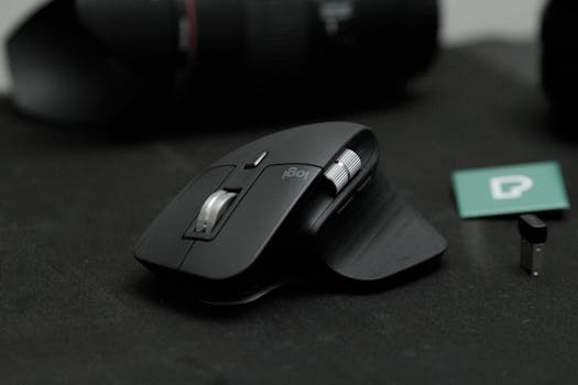 Modern wireless mouse on table with sleek design, ideal for gaming setups.