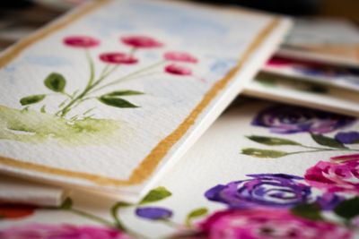 Stack of loose watercolour floral studies on cotton paper — photo by Maria Petersson on Pexels