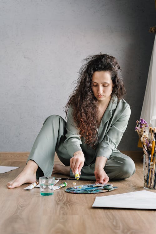 A Woman Squeezing Paint from a Tube