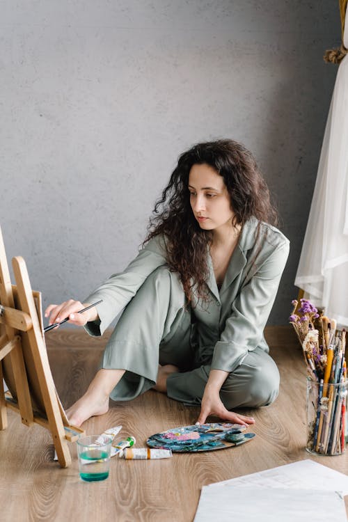 A Woman in  Her Pajama Painting at Home