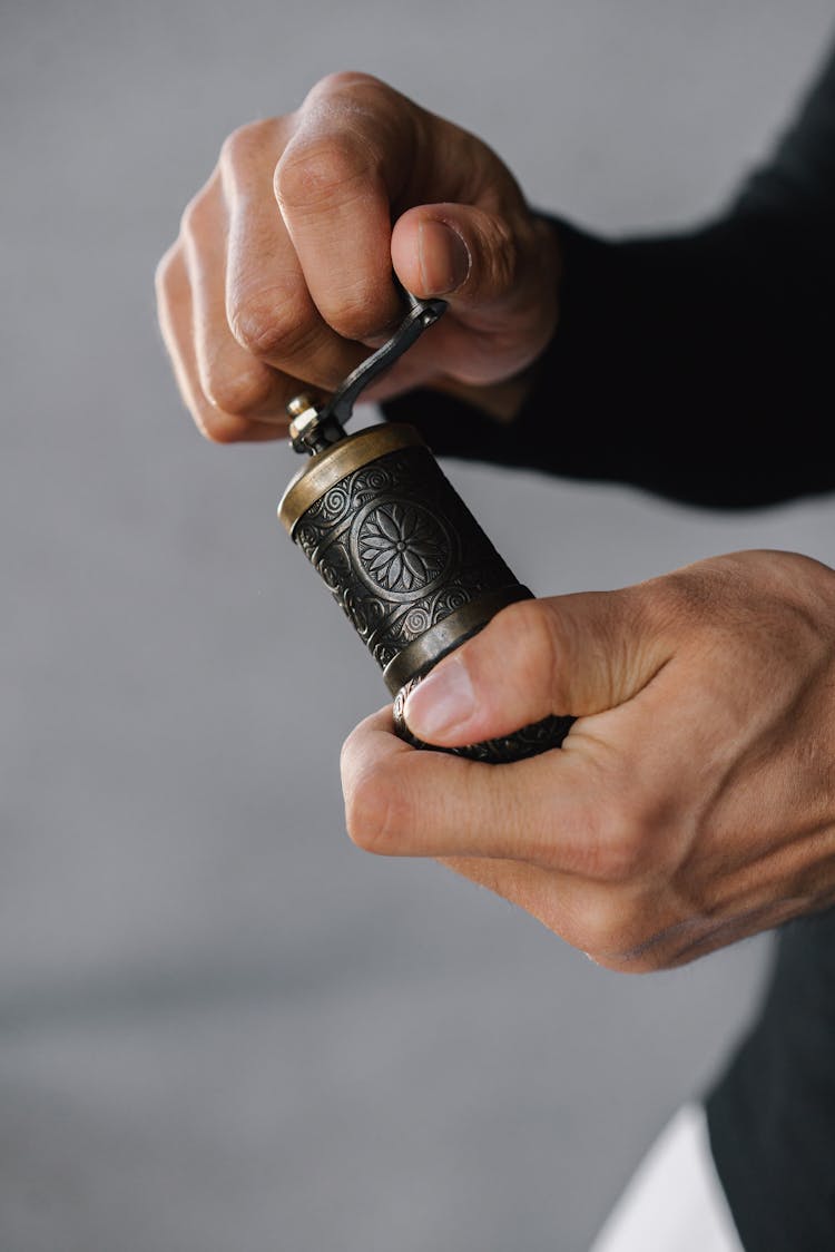 A Person Holding A Weed Grinder