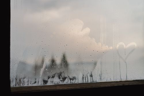 Free A heart drawn on a foggy window with dewdrops, creating a dreamy and romantic atmosphere. Stock Photo