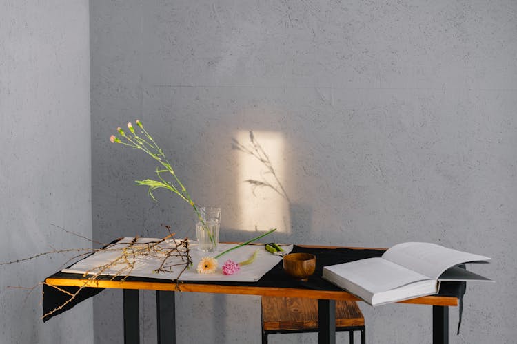 Dried Flowers And Open Book On Wooden Table