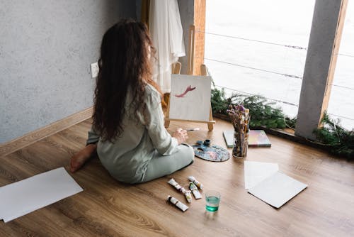 A Person Painting while Sitting on the Floor