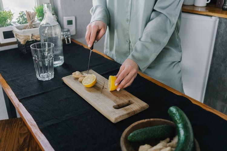 A Person Slicing A Lemon