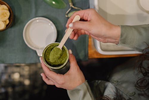 Free A Person Getting a Spoon of Matcha Powder  Stock Photo