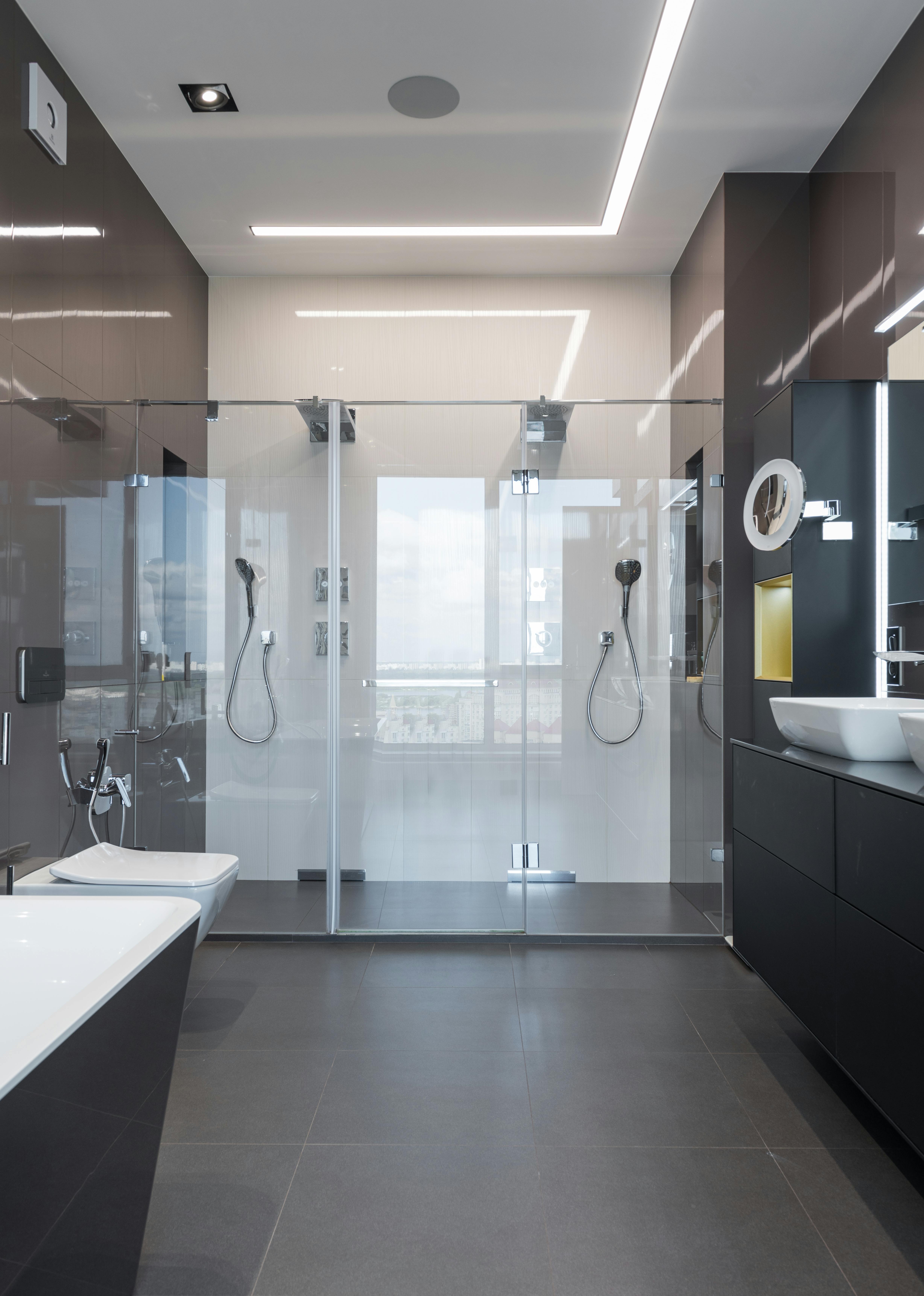 interior of spacious bathroom with shower cabin in modern apartment