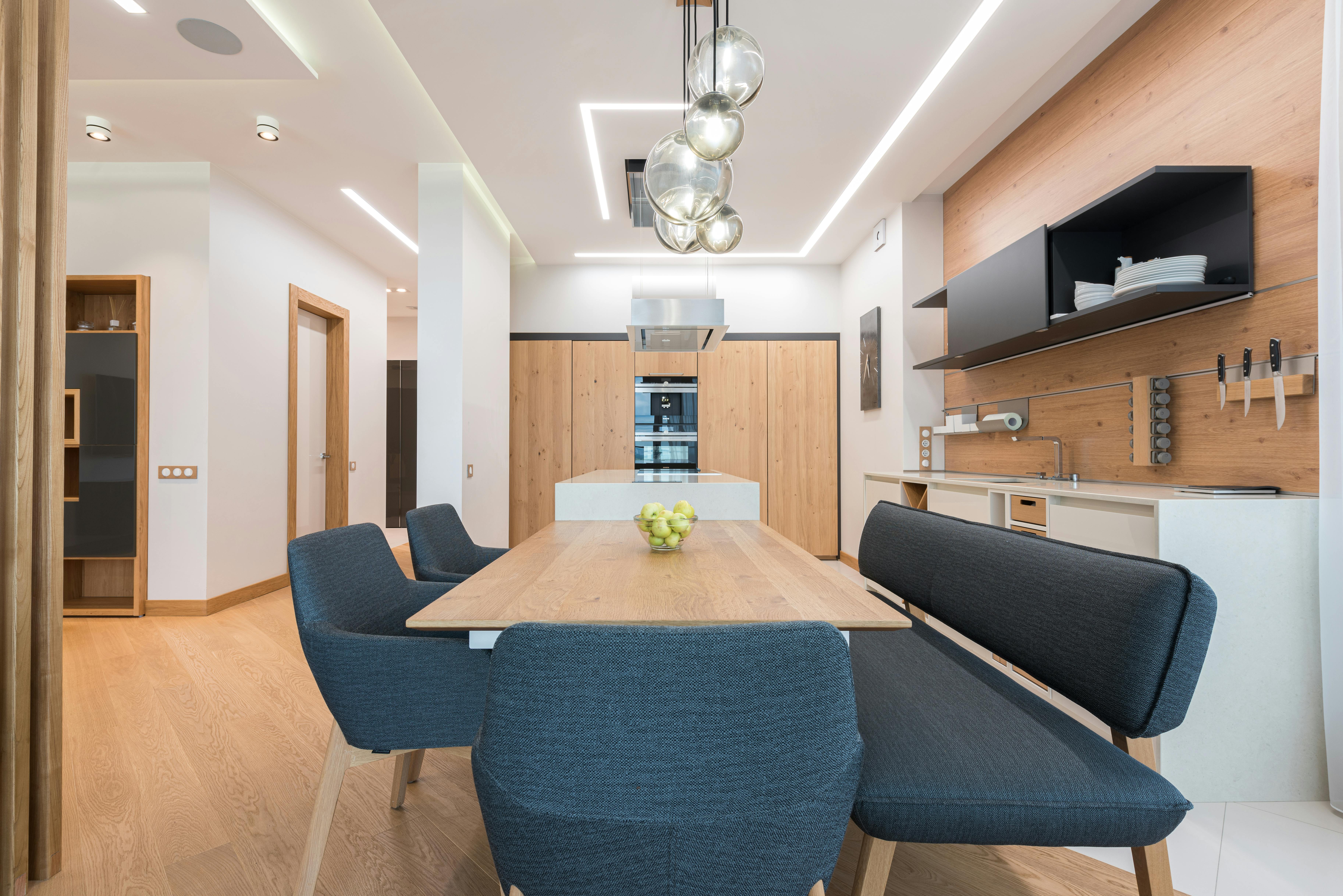 interior of modern kitchen with dining zone and wooden furniture