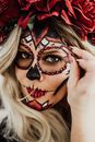 A Woman with Face Paint Putting Bids on Her Face
