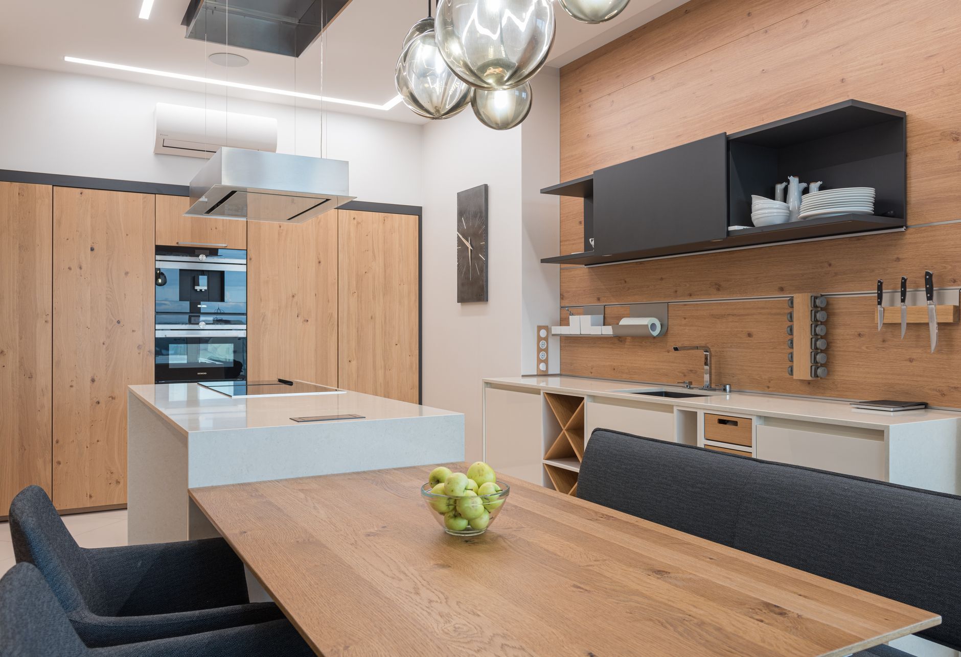 Interior of contemporary kitchen with chairs and table with vase of fresh green apple