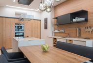 Modern kitchen with black cupboard and brown table