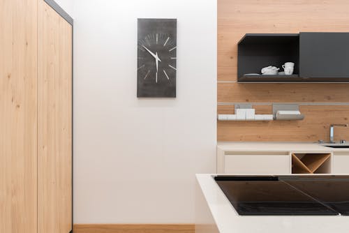 Interior of modern kitchen with cupboard full of white utensil in contemporary apartment