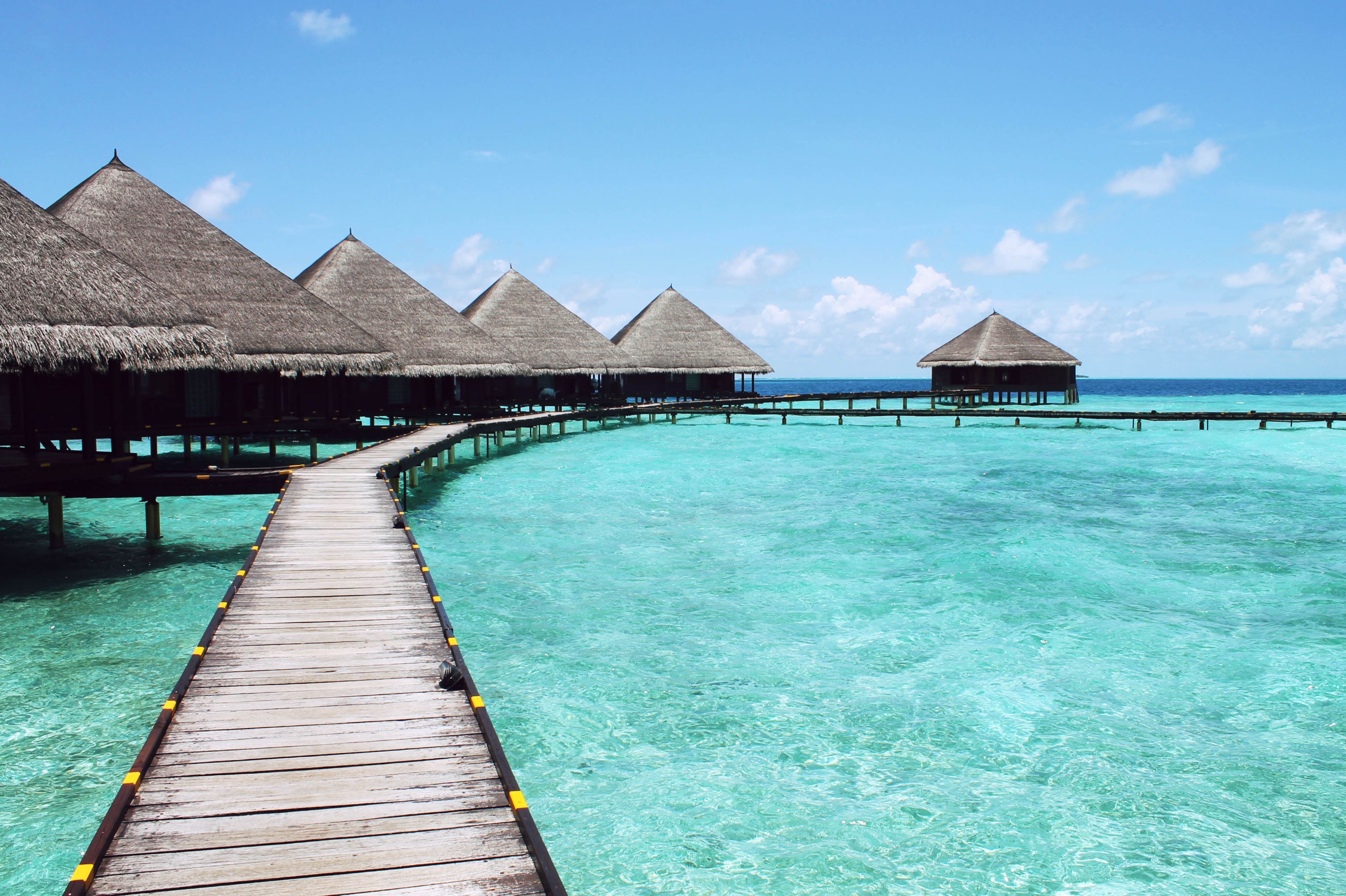 Scenic view of overwater bungalows on a tropical lagoon, perfect for a serene getaway.