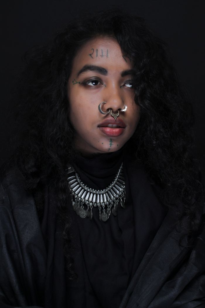 Woman with a septum piercing in dramatic light