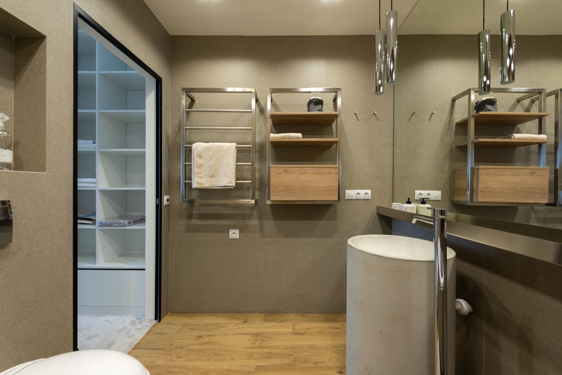 Modern bathroom with open wall shelves and towel storage