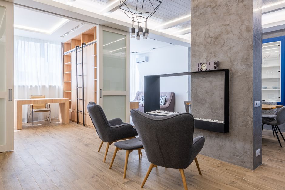 Spacious modern living room with minimalist decor, elegant furniture, and natural light.