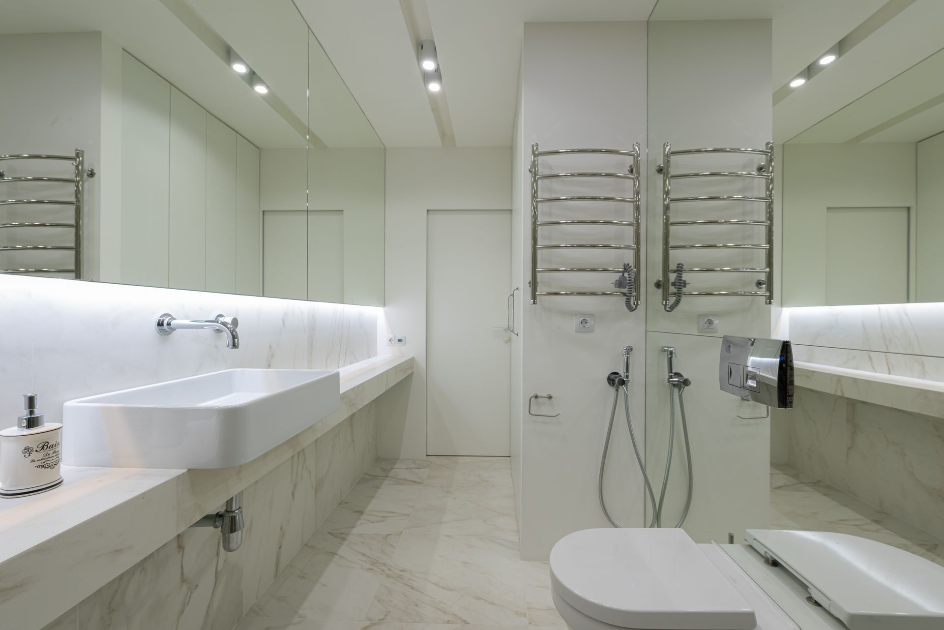Elegant bathroom design with sleek fixtures and marble surfaces.