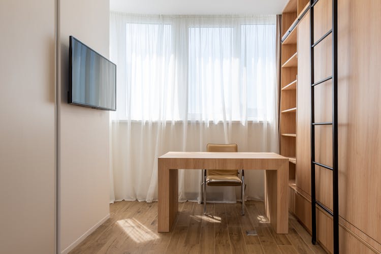 Wooden Table With Chair Near Cupboard In Study Room