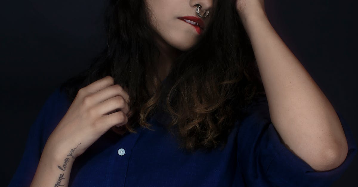 Woman Wearing Blue Button-up Blouse Bitting Lip