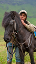 Ethnic man leaning on horse in field