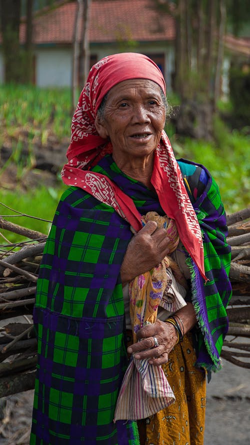 Elderly ethnic woman in traditional wear in countryside