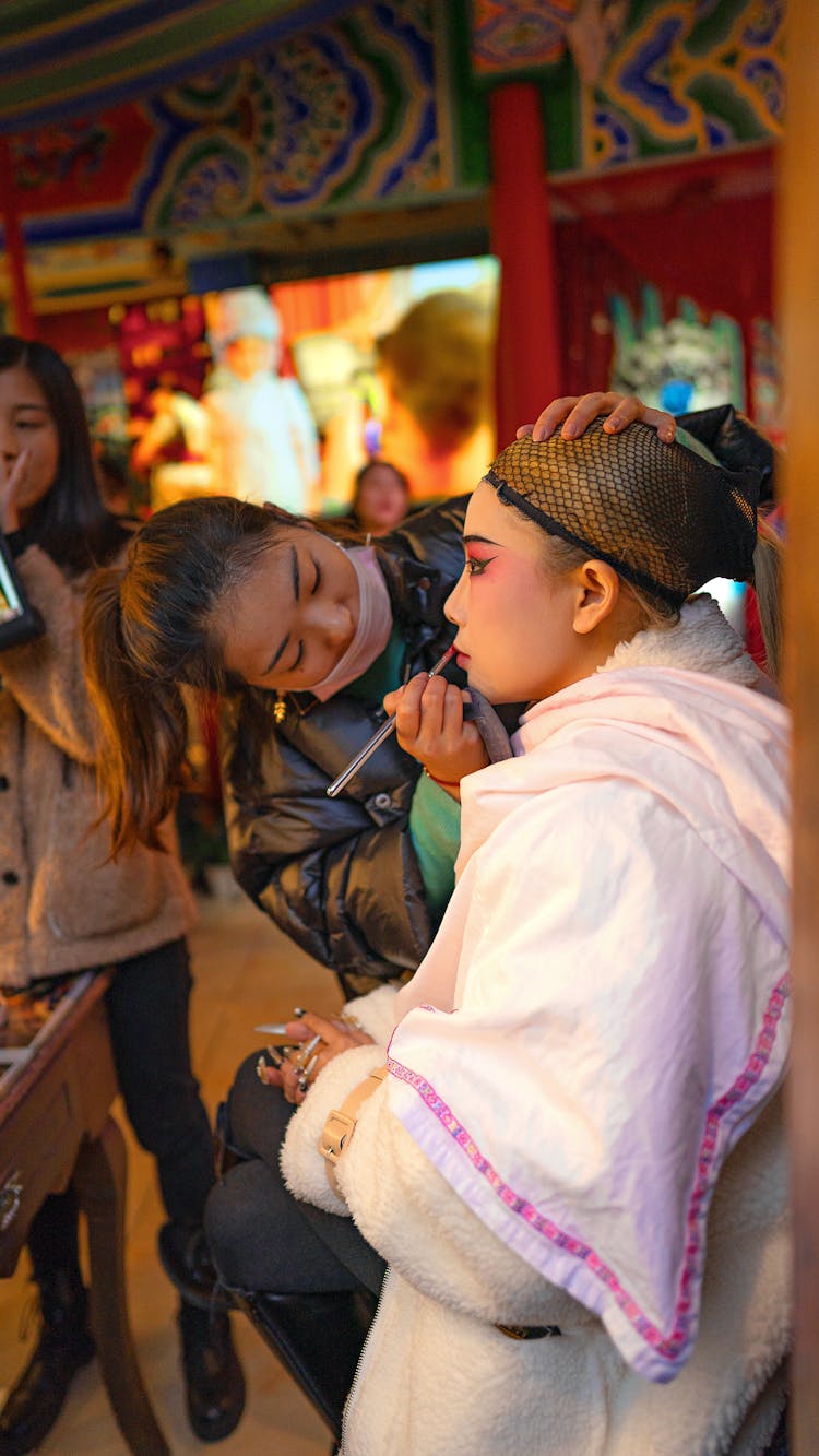 Asian Beauty Master Making Up Actress In Outerwear