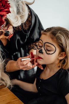 A woman applies Day of the Dead makeup to a young girl in Erfurt, Germany.