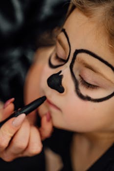 Close-up of a child with creative makeup resembling a Halloween theme in Erfurt, Germany.